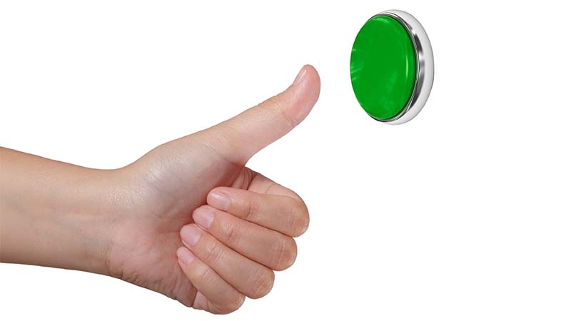 Hand Pressing Green Button