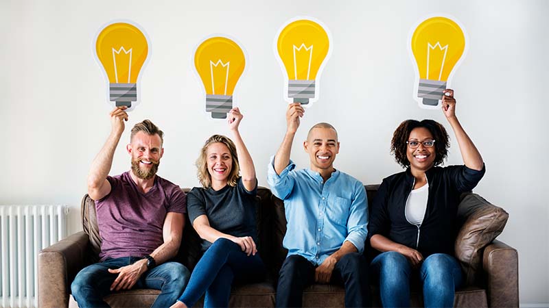 People Holding Lightbulb Icon